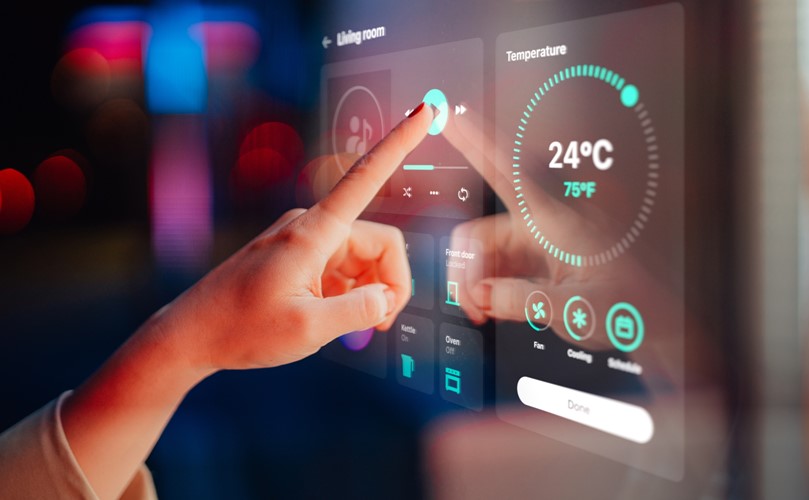 A person adjusting the room temperature by monitor