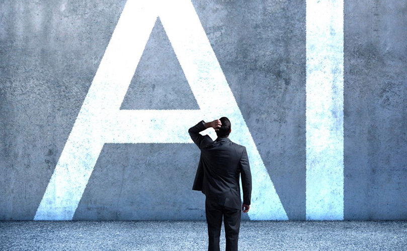 Image of a businessperson standing in front of a large concrete wall