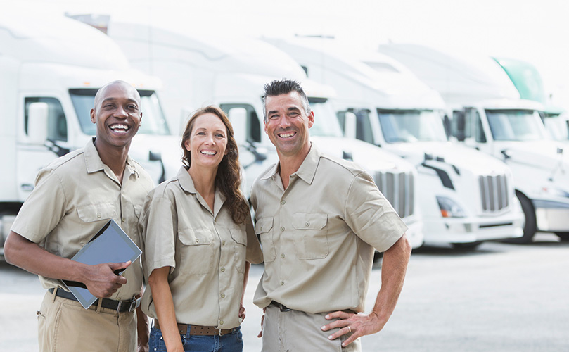Three business associates in line in front of the truck