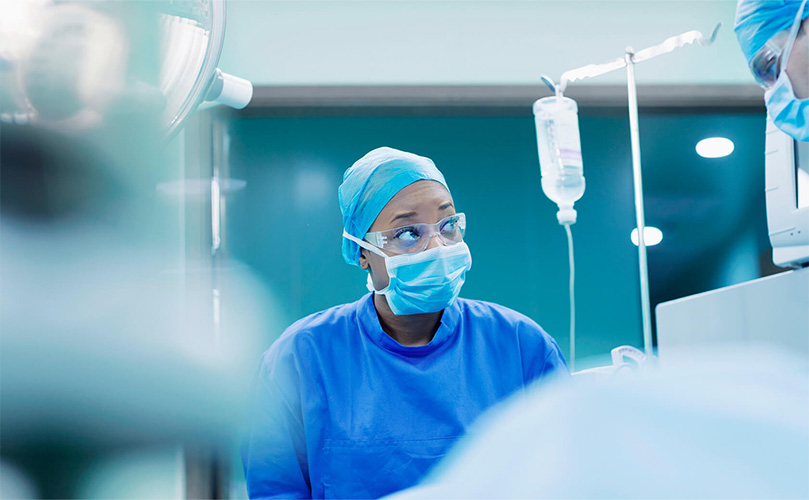 A female nurse checking monitors in the operating room