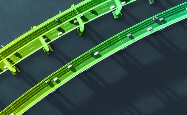 Aerial view of two green highways with cars.