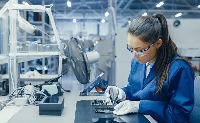 Woman welding electronic components