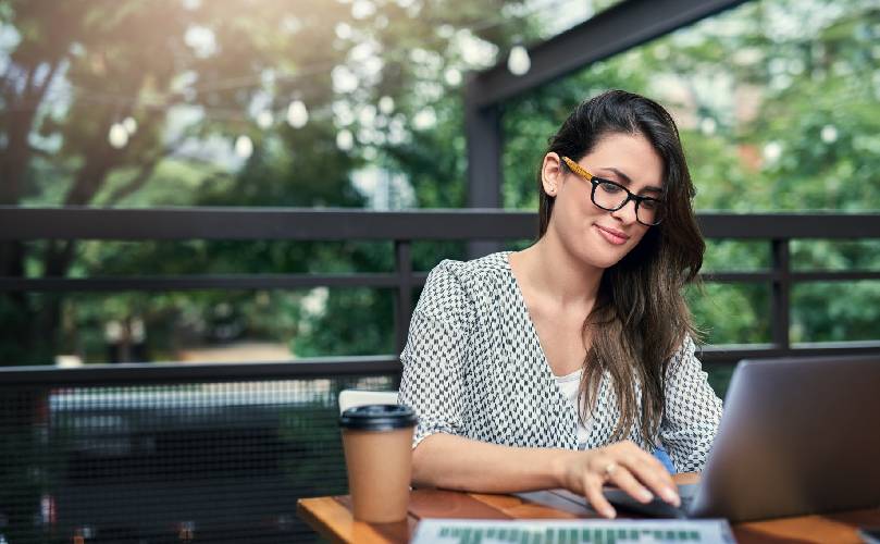  Young woman working with a laptop remotely,  outdoor