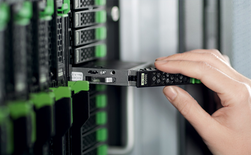  A hand of a person adjusting a component in datacenter rack